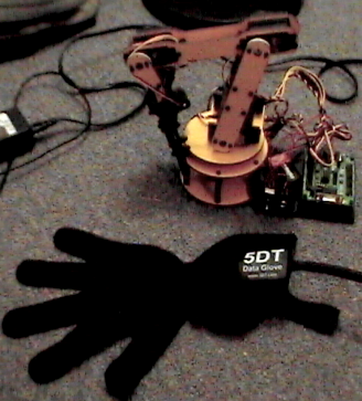 A robot arm and glove with wires running between them.